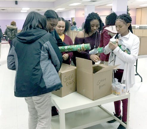 Members of the Phoenix Outreach Club filling Thanksgiving baskets for Jerry L. White and RHS families who are in need this holiday season. Photo courtesy of Develyn Newell.