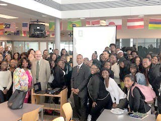 Seniors Amir Johnson, D’aja Wittfield, and &nbsp;Imani Hall-Jennings stands with President James M. Smith of Easter Michigan.