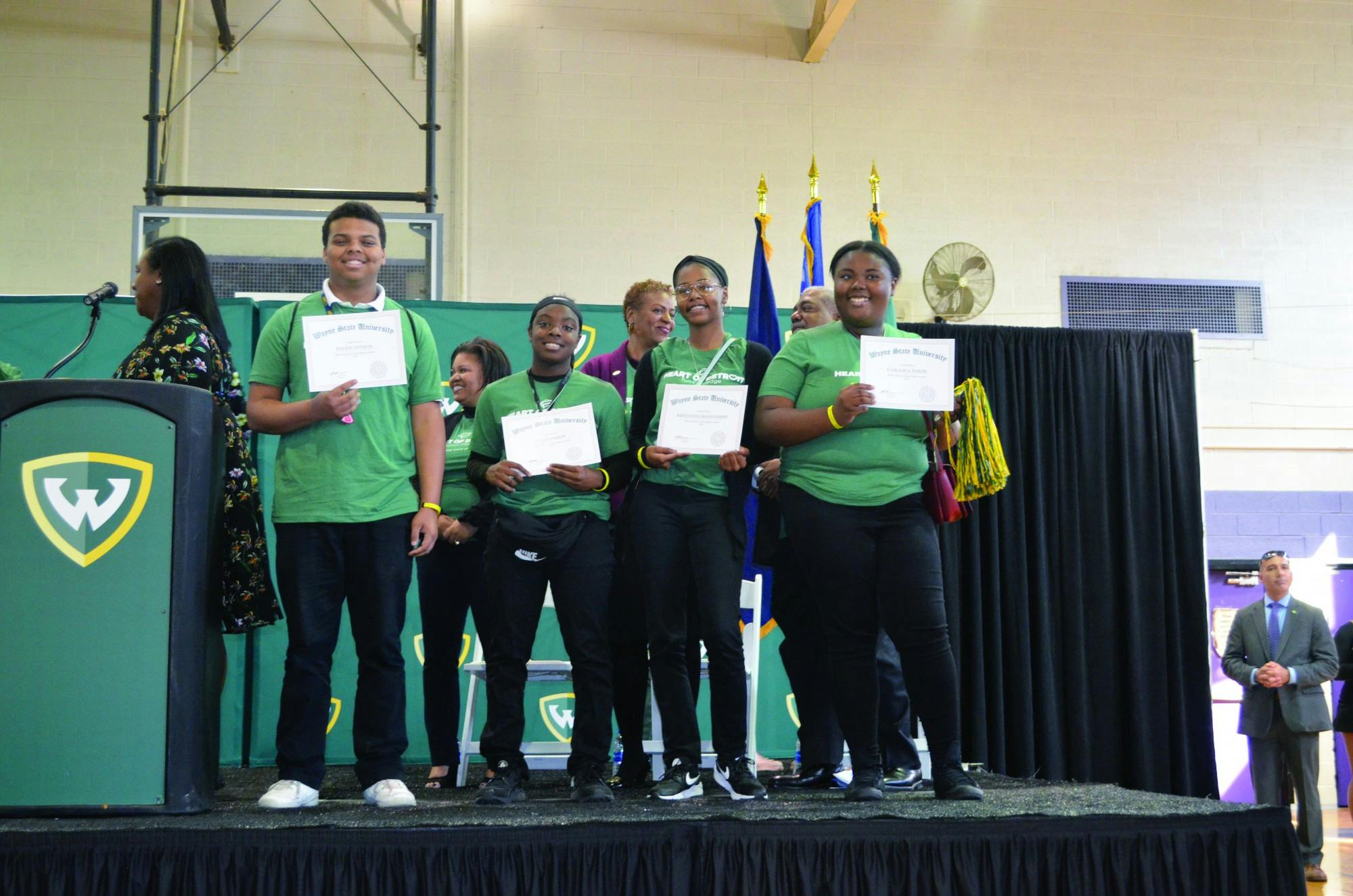 Seniors Davion Stinson, Tyler Parker, Kristianna Montgomery, and Kahliah Baker receive their scholarships to Wayne State University.
