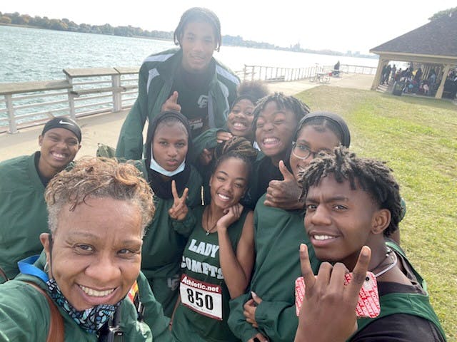 The Cody cross country team poses with Coach Watkins after a tough meet. Courtesy photo.
