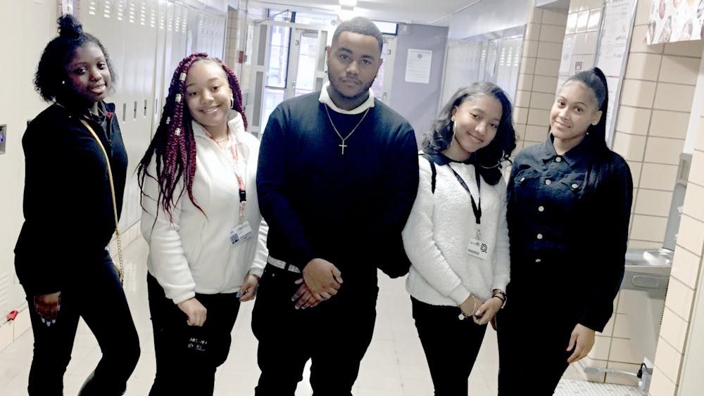 Juniors Kalen Neal, Kimberly Horton stand with senior Dy’quann Williamson, junior Jazmine Colton, and senior Corrina Coleman as they pose to show their take on school uniforms. 