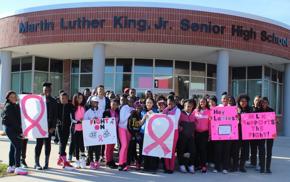 <p>Students in their pink attire prepare for the Breast Cancer Awareness march.</p>