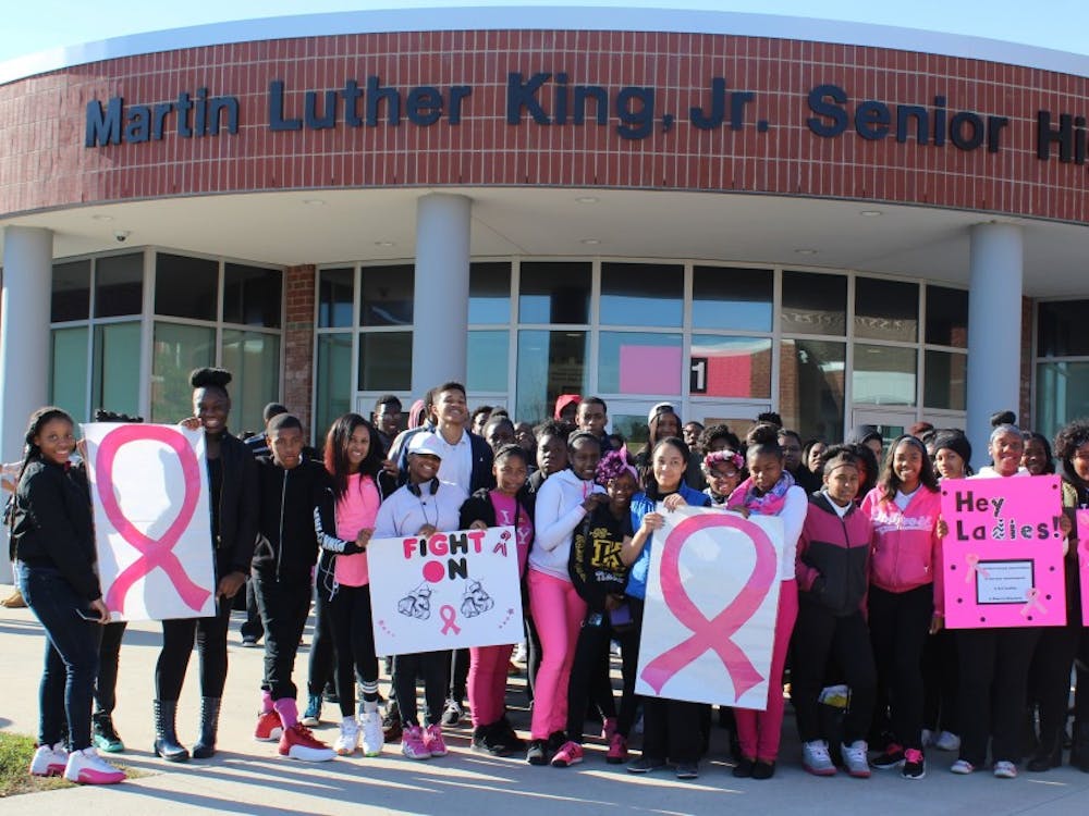 Students in their pink attire prepare for the Breast Cancer Awareness march.