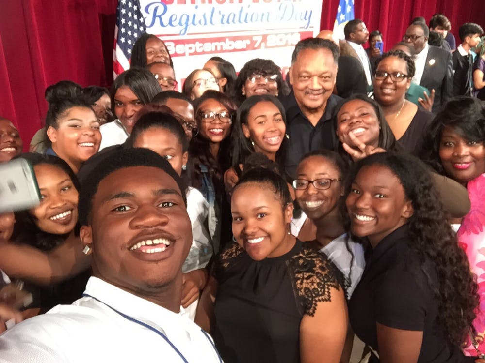 Principal Lisa Phillips and civil rights activist Jesse Jackson take a&nbsp;selfie with Cass Tech seniors&nbsp;following his inspiring speech during Cass Tech's National Registration Day Rally on&nbsp;Sept. 7.