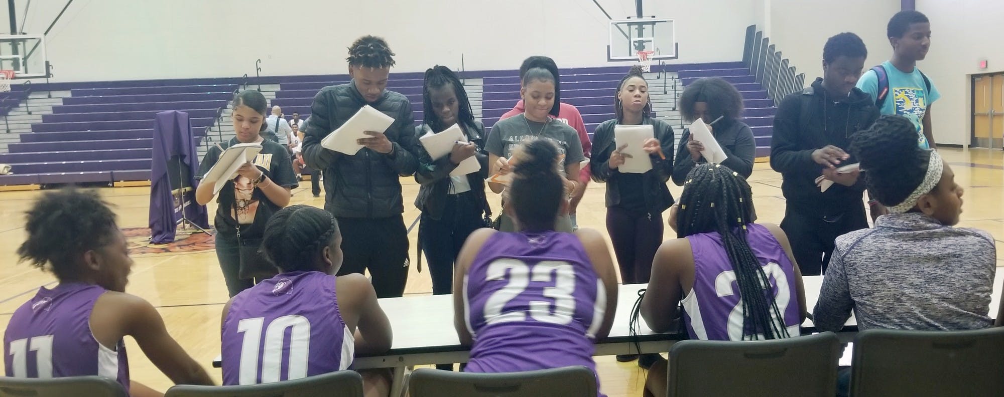 Southeastern journalism students interview the girls basketball team as part of a Sports Media Day organized at the school.