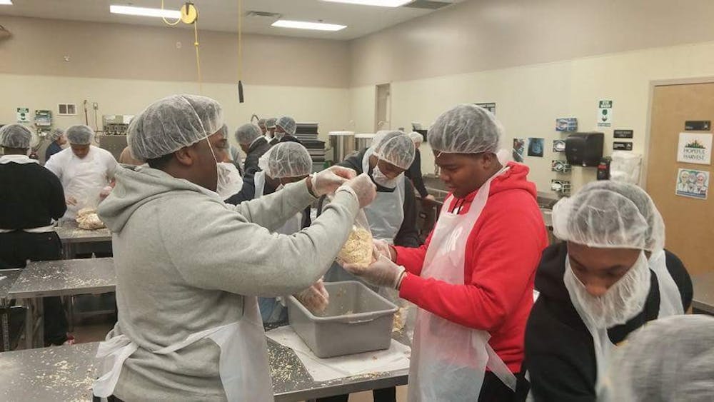 King’s varsity football team goes to the Forgotten Harvest food pantry to lend a helping hand.