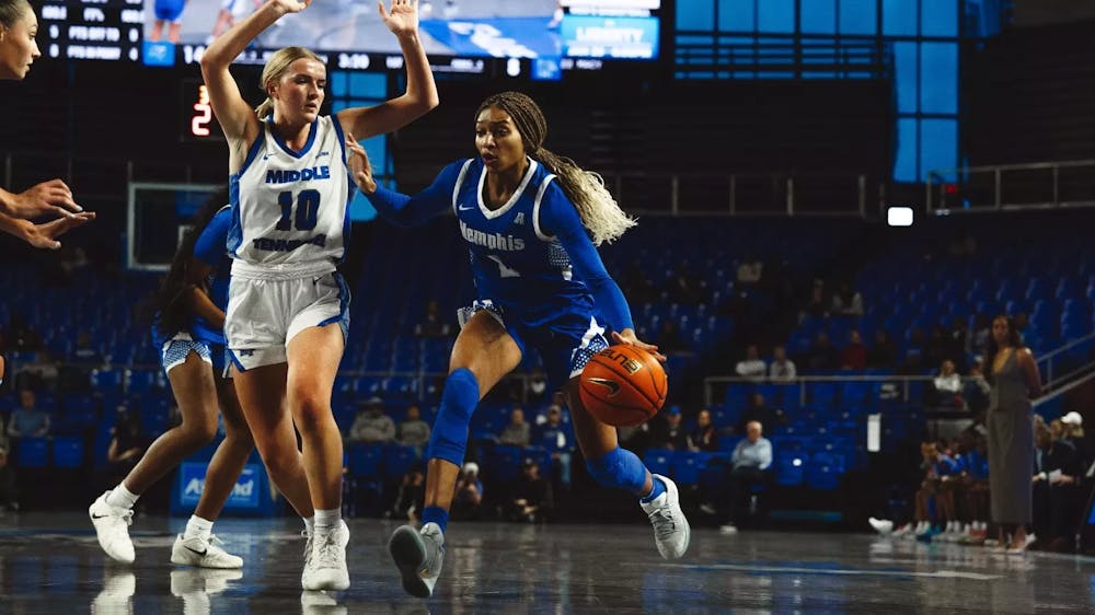 Memphis guard Jordan Hunter dribbles by an MTSU defender in the Tigers- 60-51 loss on the road on Dec. 7, 2025.