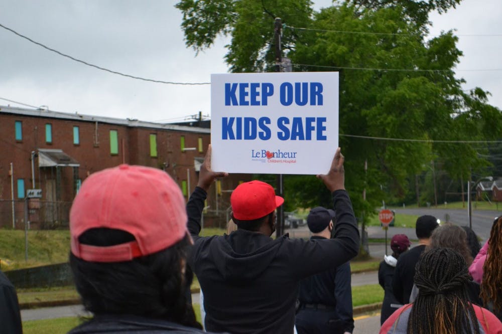 <p>A man holds up a sign for child victims of gun violence. One of victims of the city’s 87 homicides this year was a 4-year old child.</p>