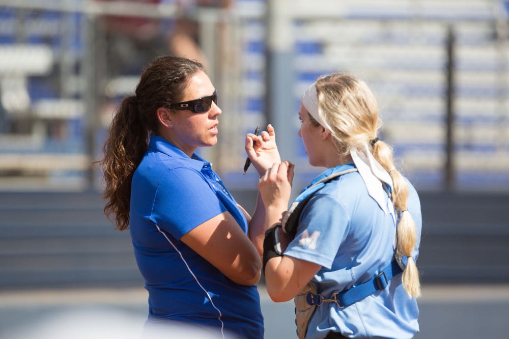 <p>Coach Natalie Poole gives instructions to catcher Regan Hadley during a Tigers game last season. Poole has led the team to 30 wins in her seventh season as head coach.</p>