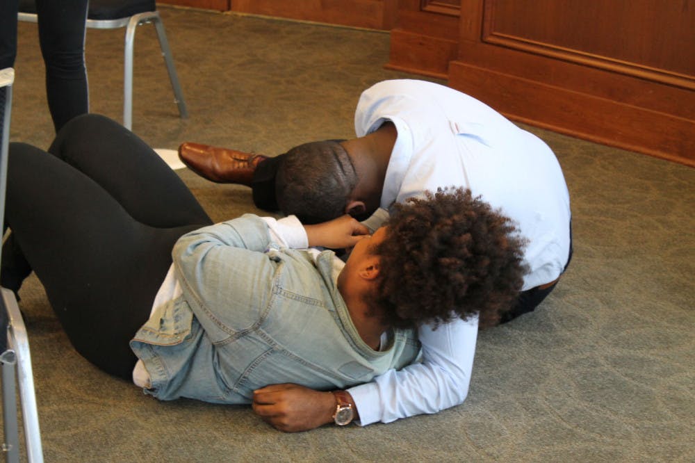 <p>Kevyanna Rawls and Antonio Scott fall to the ground as the hear they won. Rawls and Scott had worked hard to win, and they felt accomplished once they heard the news.</p>