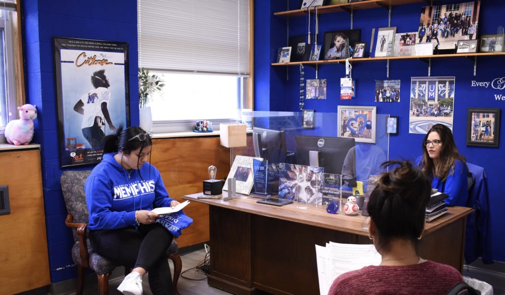 <p>Two first-gen students sit in a meeting with Jacki Rodriguez. The&nbsp;<span>Office of First Generation Student Success helps first-gen students navigate through college.</span></p>