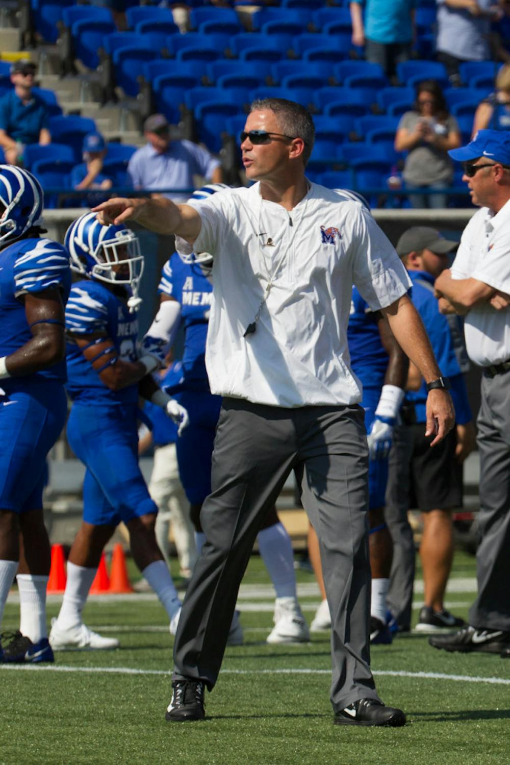 <p>Head coach Mike Norvell talks to players during the pregame warmup. Norvell is in his second season as the Tigers' coach.&nbsp;</p>