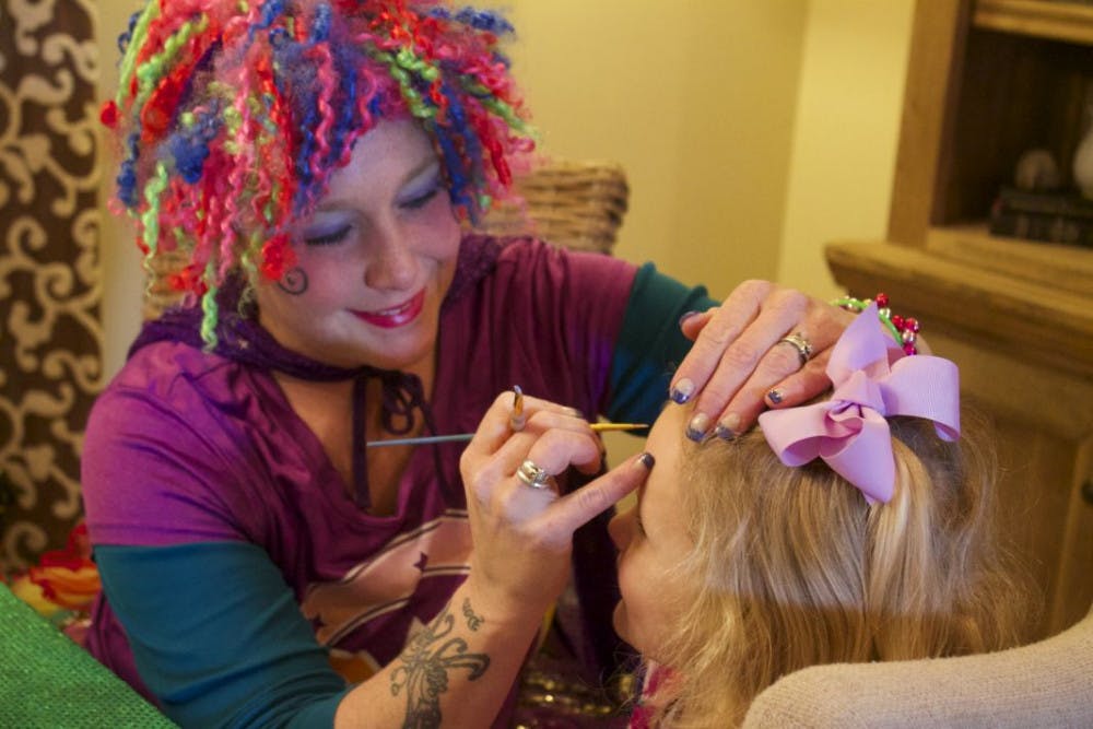 <p>Ms. Rainbow Clown, Tara Rock, transforms Reese Scruggs, a 3-year-old from Memphis, into an Elsa princess on Sunday for her birthday. Ms. Rainbow has been clowning around Memphis for over 17 years including face painting and balloon art.</p>