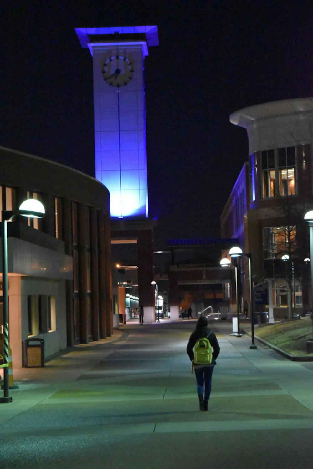 <p>A student walks down a University of Memphis walkway after sunset. A <em>Helmsman</em>&nbsp;poll found that male students felt safer on campus at night than female students.</p>