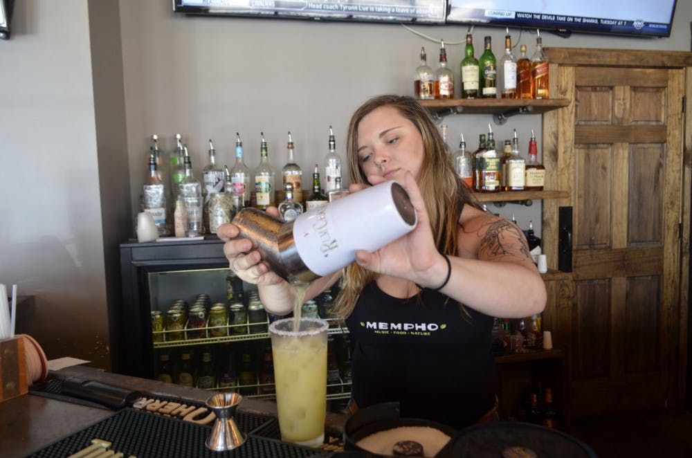 <p>Bartender Avery Parks mixes up a drink at The Bluff on the Highland Strip. Of all 41,250 total sexual assault cases reported from 2005 to 2015 in the United States, food service accounted for 14.23 percent, the most of any individual industry, according to the Center for American Progress.&nbsp;</p>