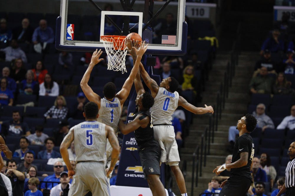 <p>Dedric and K.J. Lawson jump over a defender to grab a rebound. The two asked for a release from the University of Memphis Basketball Program Wednesday.</p>