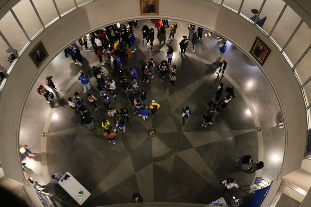 <p>Students gather in the Ned McWherter library for silent disco. The Student Activities Council and the Blue Crew organized many events for Homecoming week.</p>