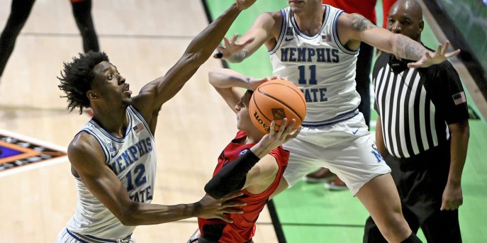 <p>DeAndre Williams and Lester Quinones trap a Dayton guard during the first round of the NIT. The Tigers would go on to win 71-60 against the Flyers and face Boise State in the quarterfinals on Thursday.&nbsp;</p>