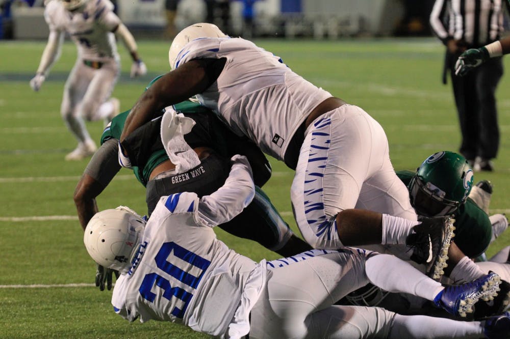 <p>O'Bryan Goodson and Shareef White combine for a tackle in the 2017 football season.</p>