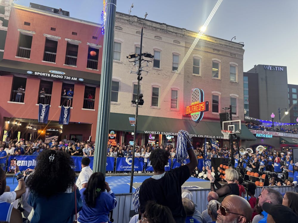Fans cheer on the festivities beside the temporary court on Beale Street at Memphis basketball's Ballin' on Beale event Thursday night.