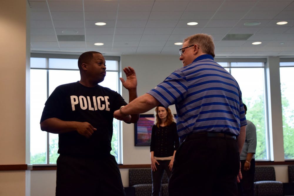 <p class="p1">Sgt. Marco Anderson demonstrates self-defense moves in Tuesday’s safety seminar with accounting instructor Philip Babin. Police Services showed basic self-defense techniques to be used as a last resort.</p>