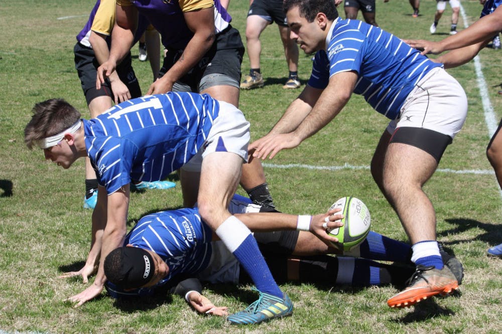 <p>Ryan Coleman places the ball towards the Tigers as Ethan Scott (left) and Musa Banat (right) form a ruck. Memphis Rugby beat the University of North Alabama Lions 38-12.</p>