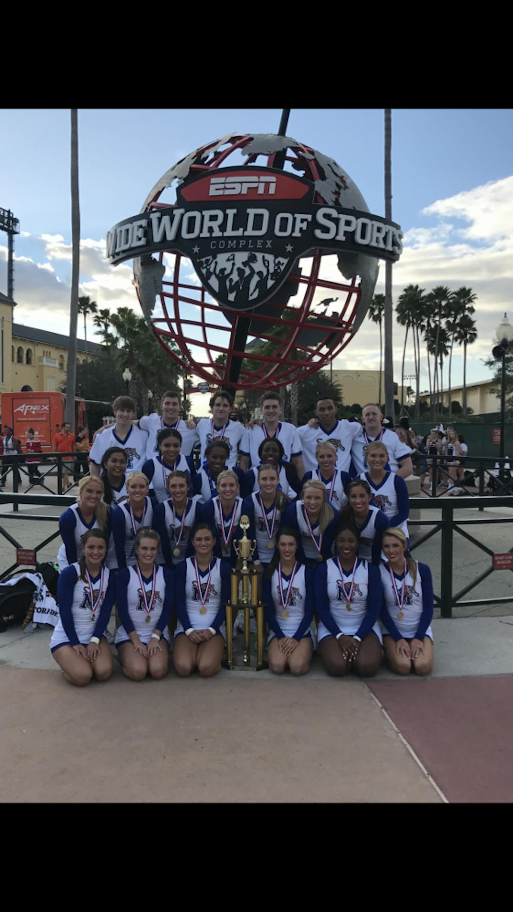 <p>The cheer team poses with their trophy and medal at the ESPN complex in Orlando, Florida. This win marks their fifth national championship win.</p>