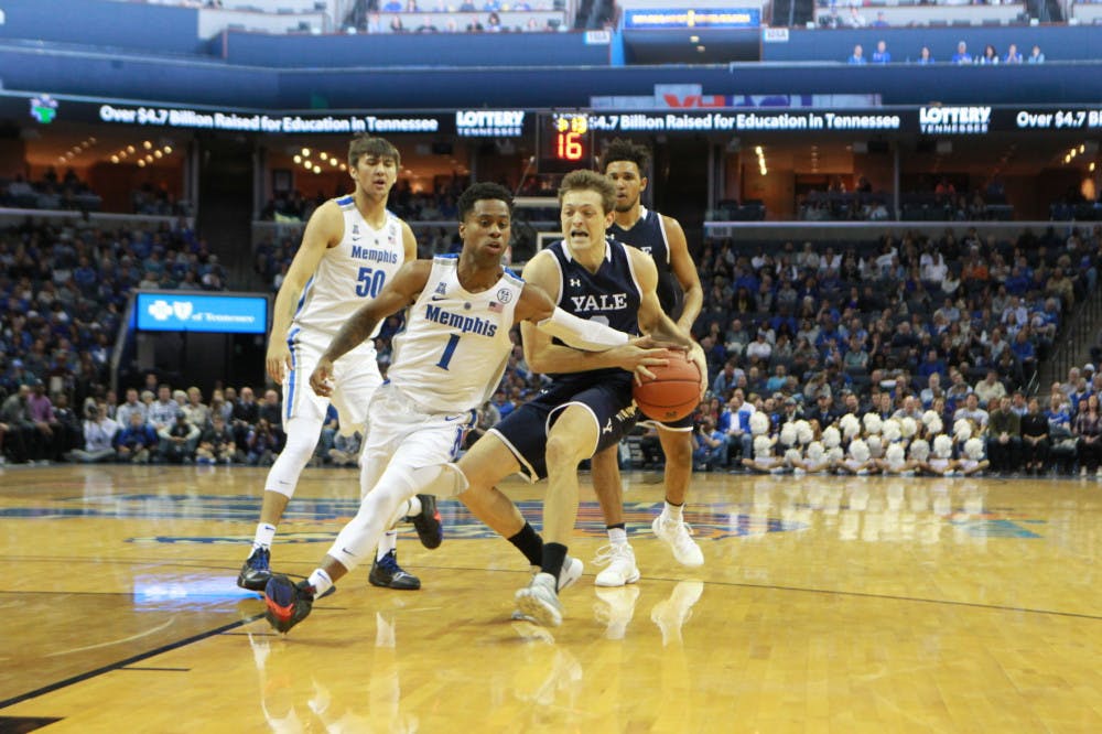 <p>Freshman guard Tyler Harris attempts to steal the ball away from a driving Yale player.&nbsp;</p>