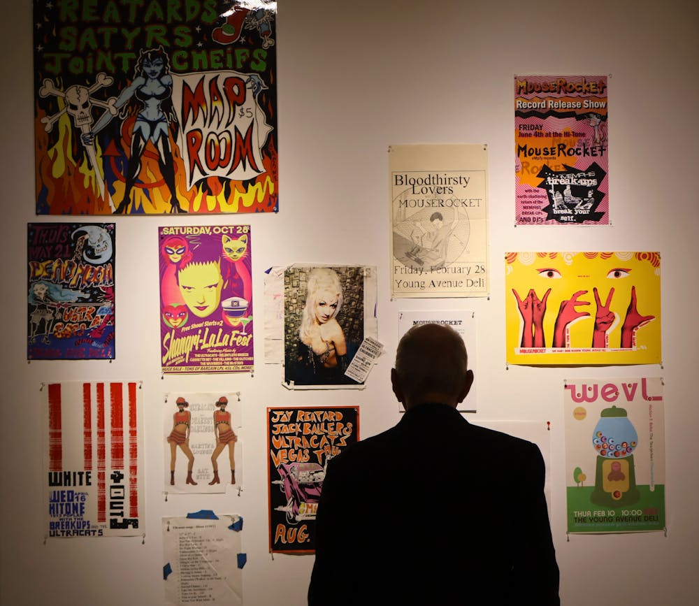 <p>A visitor observes a wall of colorful posters during the opening reception of the Mexican art exhibit Sept. 6 at the University of Memphis Art Museum.</p>