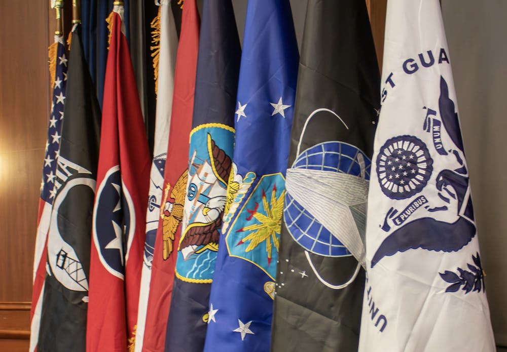 <p>Flags designed to represent all veteran branches hung proudly at the Student Veteran graduation ceremony in the UC Fountain View room on Tuesday evening.</p>