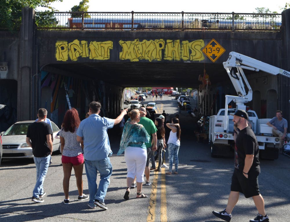 <p>Spectators enter the Paint Memphis festival to observe the artistic talent of the over 150 artists who participated in this year’s event.</p>