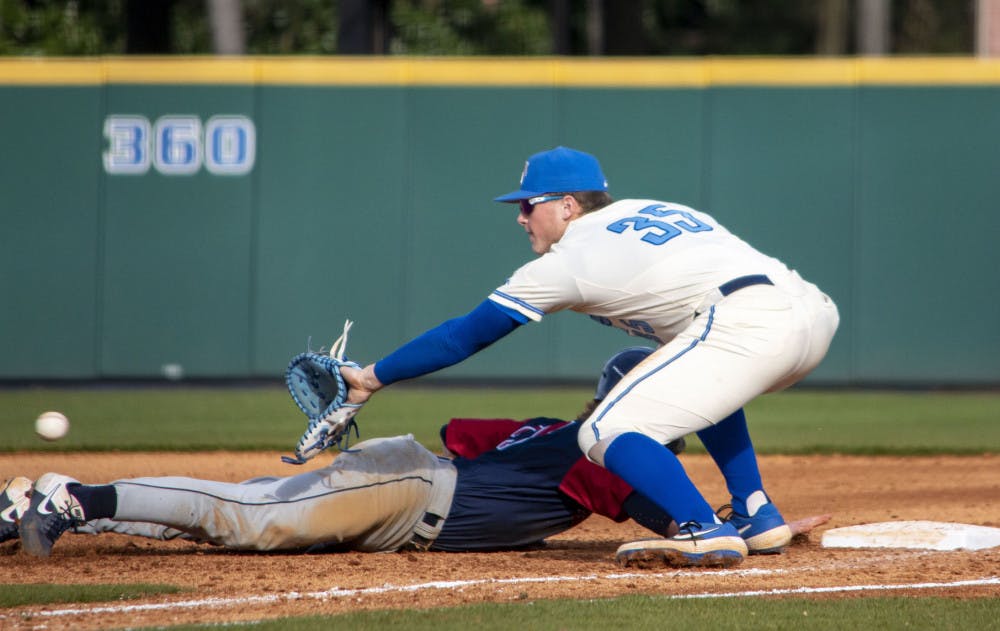 <p>Hunter Goodman attempting to get the player out at first against Dayton on Feb. 22, 2020. The Tigers have their first road series of the year against UNC Wilmington this weekend.&nbsp;</p>