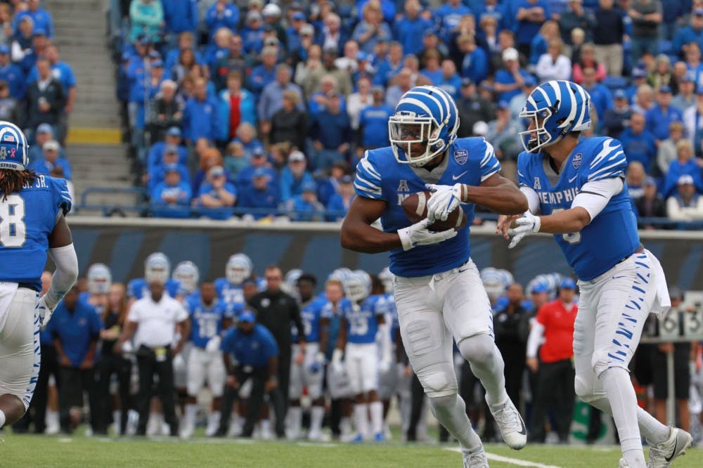 <p>Brady White hands the ball off to the running back. Memphis was held scoreless in the second half in the losing efforts against UCF.</p>