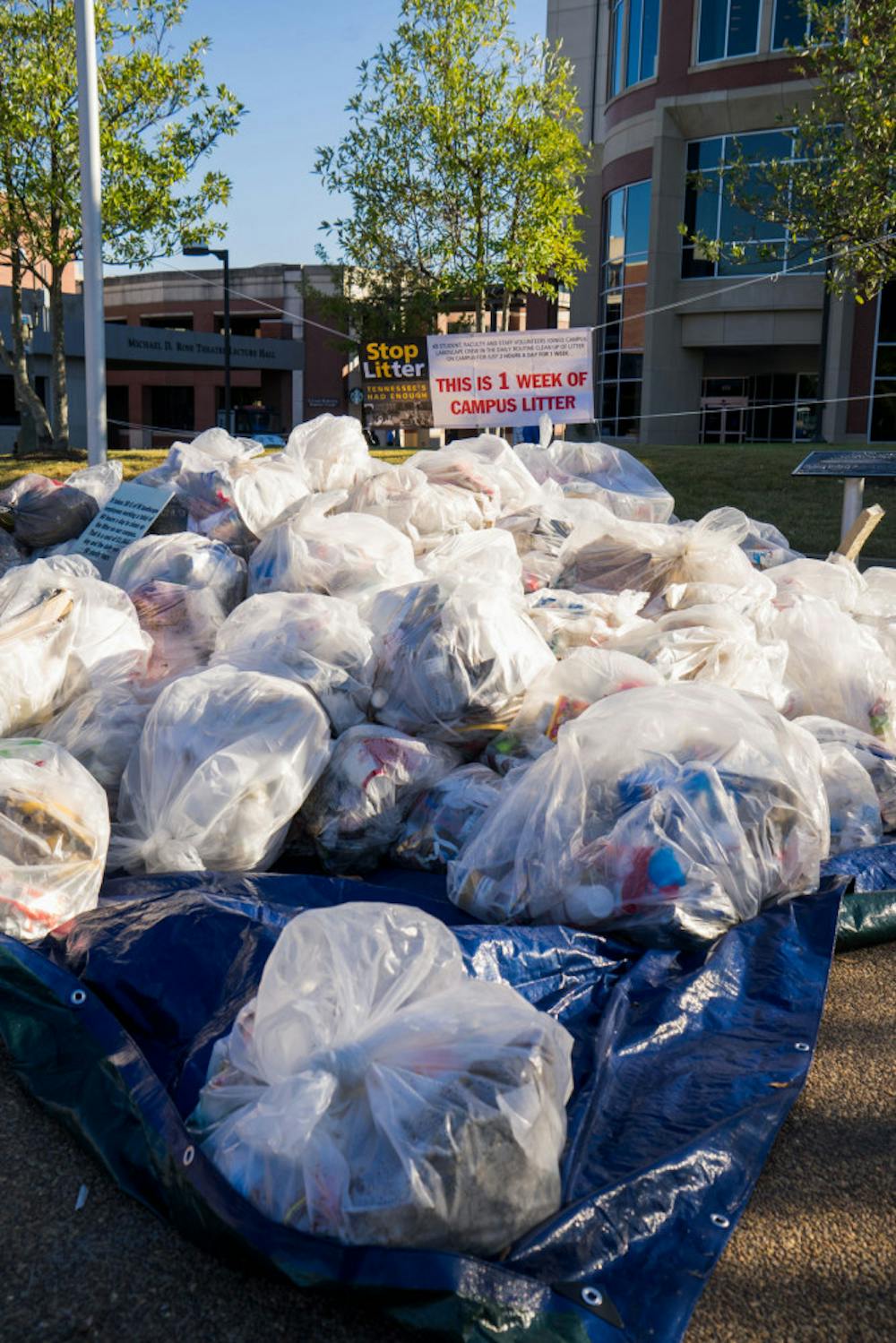 <p>Trash bags laid out at the University Fountain Wednesday illustrate what one week of on-campus litter looks like. The Sustainability Committee educated students at the demonstration on the importance of recycling.</p>
