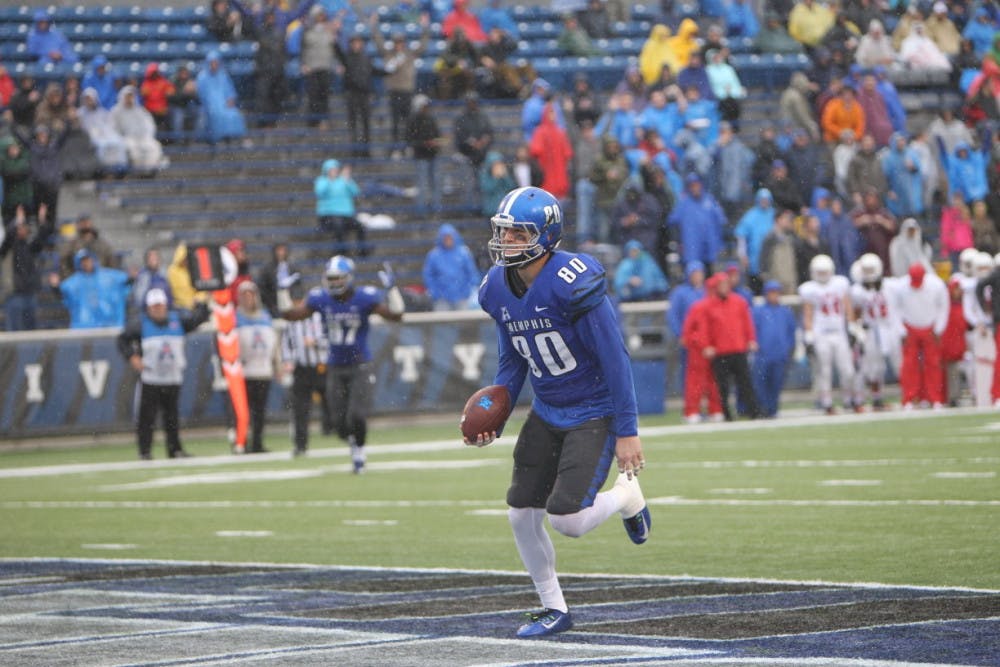 <p>Tigers tight end Daniel Montiel walks into the end zone after catching one of Paxton Lynch's seven touchdown passes in Memphis' 63-0 victory over SMU.&nbsp;</p>