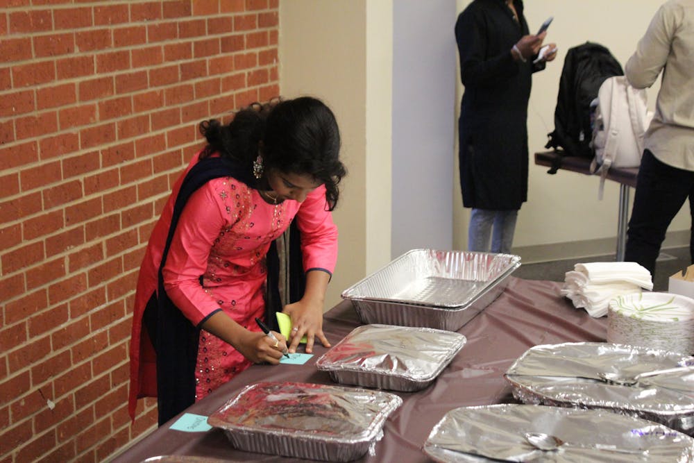 Student members of ISA preparing their meals for the Diwali Potluck. Photo credit to Darien Anderson