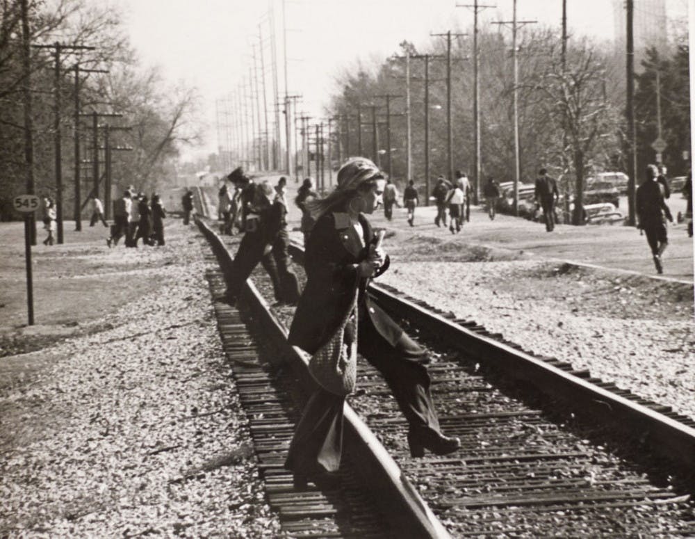 <p class="p1">University of Memphis students have crossed the Southern Avenue train tracks for decades. But</p>
<p class="p1">where a student can cross is going to be limited in the coming months when U of M officials build</p>
<p class="p1">a fence along the tracks. A Daily Helmsman photographer snapped this photo of students crossing</p>
<p class="p1">the tracks in 1974.</p>