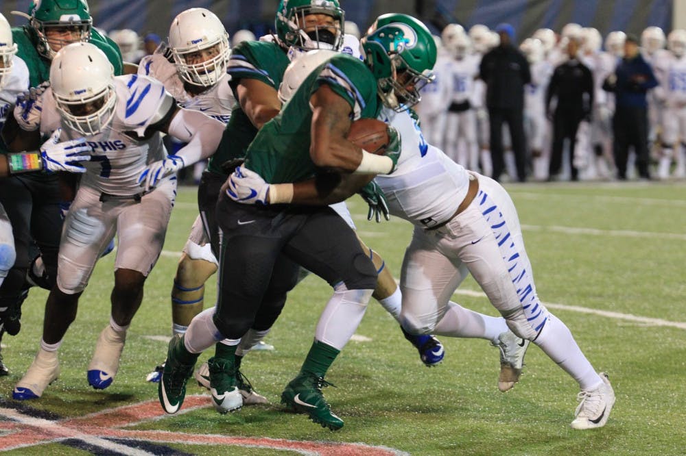 <p>Tim Hart makes a tackle on the Tulane running back. Hart collected four tackles during the game.&nbsp;</p>