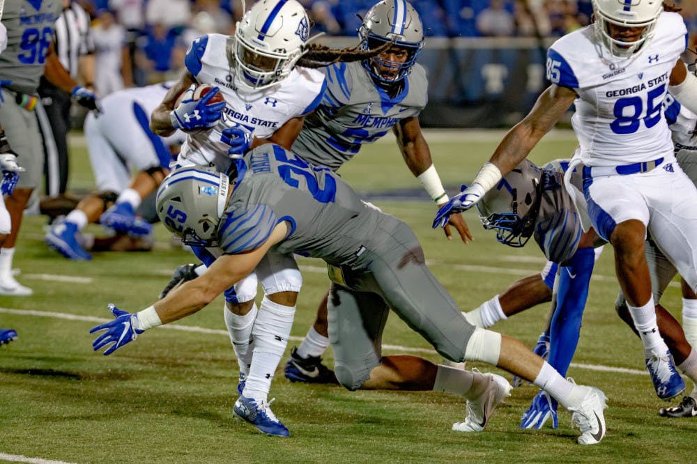 <p>Austin Hall tackles a Georgia State offensive player. The Memphis Tigers defeated the Panthers on Friday.</p>