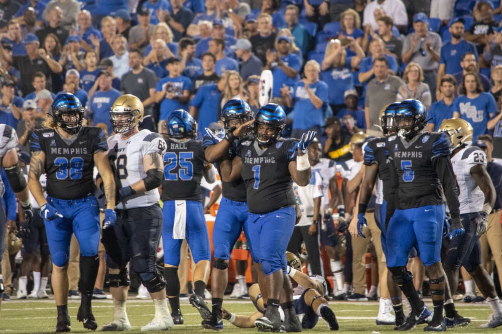 <p>O'Bryan Goodson celebrating after a hit on the Navy quarterback last year. The game between Memphis and Navy this season is uncertain after COVID-19 complications.</p>