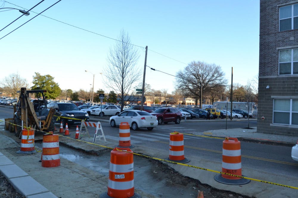 <p>Cars maneuver past construction in front of The Gather Apartments on Southern Avenue.</p>