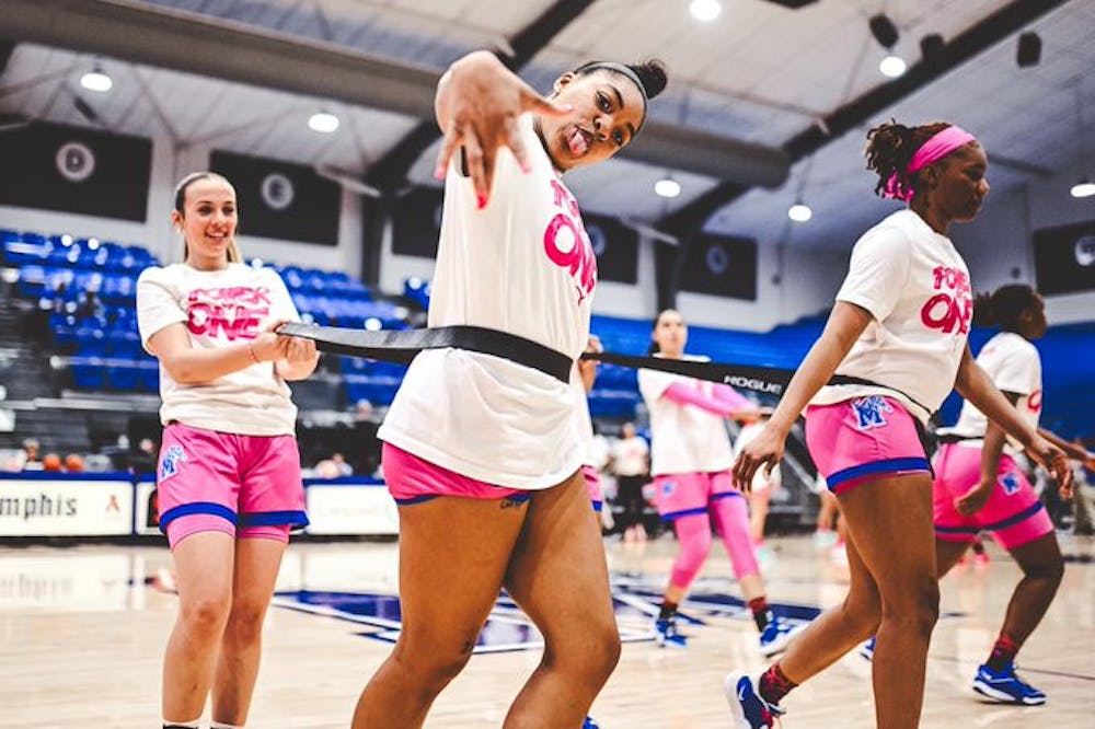 The Tigers warm up in their pink uniforms, as Memphis celebrates Play4Kay night by raising money for cancer research.