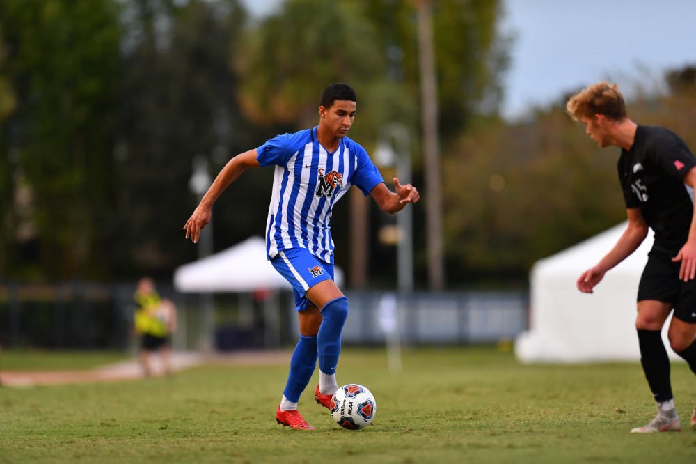 <p>Gurman Sangha, freshman midfielder, tries to dribble past an SMU defender. Sangha earned All-Rookie Team honors and finished with a goal and two assists in the AAC Championship.&nbsp;</p>