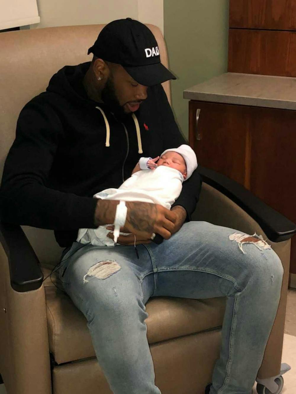 <p class="p1"><span class="s1">Mike Parks, the center for the UofM’s men’s basketball team, holds his son, Zakari Daniel Parks, who was born Jan. 5. Parks said his son will motivate him to work harder.<span class="Apple-converted-space">&nbsp;</span></span></p>