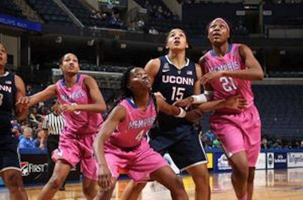 <p>Memphis players box out against UConn for a rebound last season. The Tigers will try to upset the Huskies and snap their 102 game winning streak.&nbsp;</p>