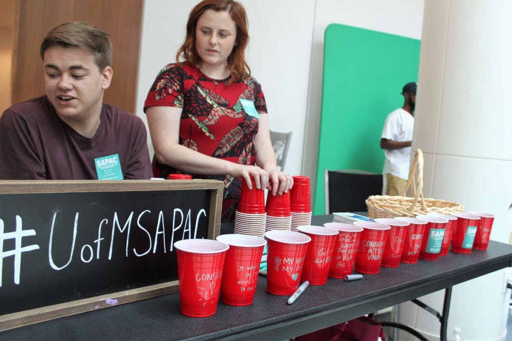<p class="p1"><span class="s1">Students write inspirational messages on the red Solo cups about consent or what consent means to them. The Solo cups represented the use of alcohol and how most assaults happen when alcohol is involved.</span></p>