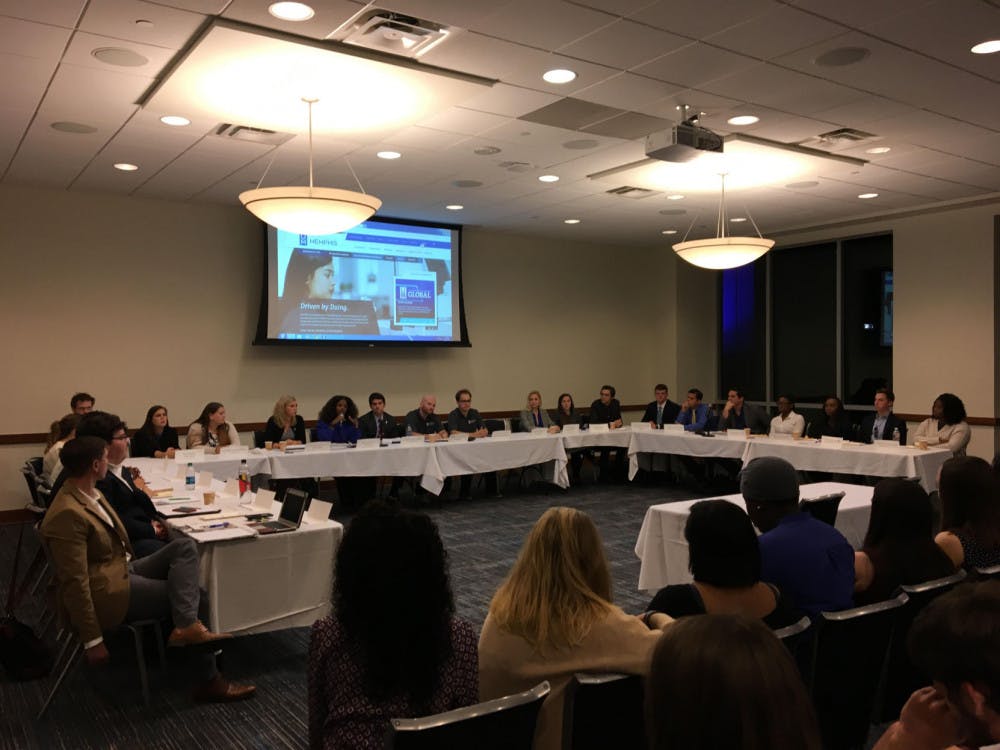 <p>Student Government Association senators sit around a table in the University Center Memphis Room Thursday afternoon answering questions from the audience during their town hall.</p>