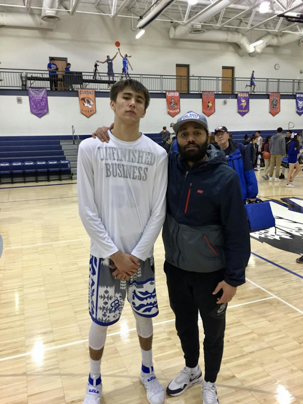 <p class="p1"><span class="s1">David Wingett, left, stands with Clint Parks on a basketball court. Wingett said he looks at Parks as not just a trainer but a mentor and big brother, too.<span class="Apple-converted-space">&nbsp;</span></span></p>