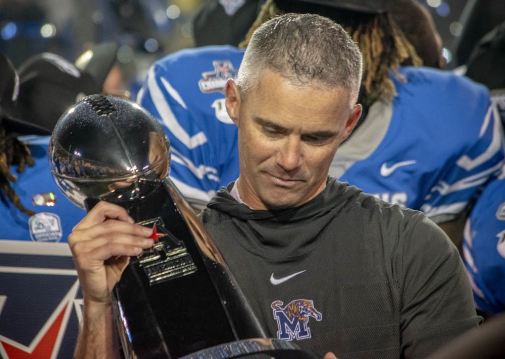 <p>Mike Norvell holding the AAC Football Championship Trophy. The conference will lose three members, leaving Memphis behind in the American Athletic Conference.</p>