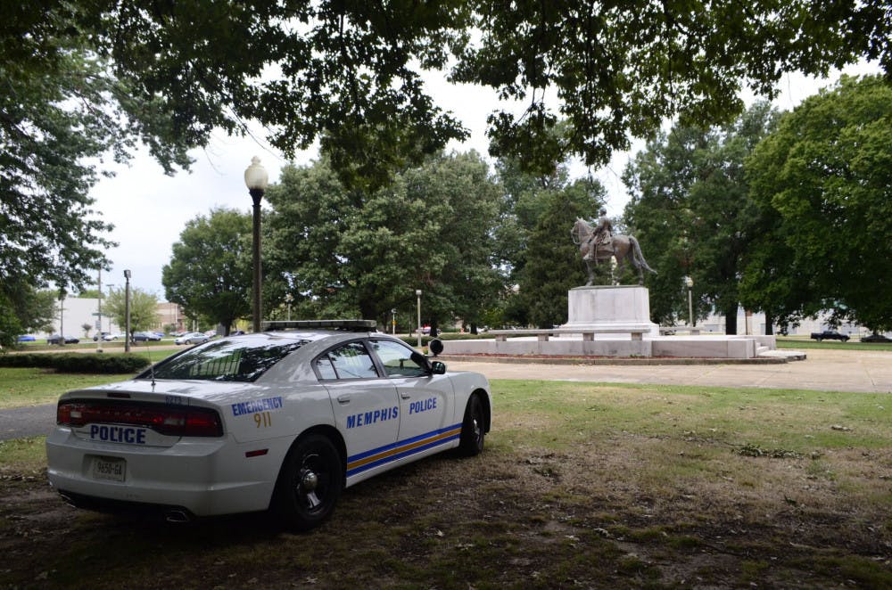 <p>A police officer monitors the Nathaniel Bedford Forrest Statue at the Health Sciences Park. Due to recent vandalism, the statue is being surveilled by officers.&nbsp;</p>